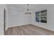 Dining Room with large windows, chandelier, and wall paneling at 858 Lake Artesia Ln, Fuquay Varina, NC 27526