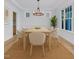 Elegant dining room featuring a modern chandelier, large windows, and wood floors at 858 Lake Artesia Ln, Fuquay Varina, NC 27526