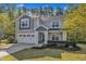 Lovely two-story home offers a well-kept lawn, attached two-car garage, and welcoming entryway at 858 Lake Artesia Ln, Fuquay Varina, NC 27526