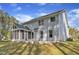 Back exterior view features a screened in porch and spacious backyard with mature trees at 858 Lake Artesia Ln, Fuquay Varina, NC 27526