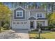 Charming two-story home featuring a well-manicured lawn, two-car garage, and inviting covered entrance at 858 Lake Artesia Ln, Fuquay Varina, NC 27526