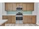 The kitchen features wooden cabinets, stainless steel appliances, modern countertops, and ample storage space at 858 Lake Artesia Ln, Fuquay Varina, NC 27526