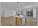 Modern open-concept kitchen featuring an island with white countertops and stainless steel appliances at 858 Lake Artesia Ln, Fuquay Varina, NC 27526