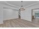Open Living Room with hard wood floors and neutral paint, flowing into the kitchen at 858 Lake Artesia Ln, Fuquay Varina, NC 27526