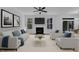 A spacious living room features neutral tones, plush seating, fireplace, and natural light streaming through large windows at 858 Lake Artesia Ln, Fuquay Varina, NC 27526