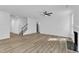 Bright, airy living room with fireplace, ceiling fan, and beautiful wood-look flooring at 858 Lake Artesia Ln, Fuquay Varina, NC 27526