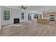 An open concept living space showcasing a fireplace, sliding glass doors, and kitchen island at 858 Lake Artesia Ln, Fuquay Varina, NC 27526