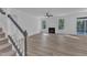 Living room features fireplace, ceiling fan, wood-look floors, and access to a screened porch at 858 Lake Artesia Ln, Fuquay Varina, NC 27526