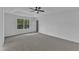 The primary bedroom has a trey ceiling, ceiling fan, and a view to the backyard at 858 Lake Artesia Ln, Fuquay Varina, NC 27526