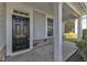 Covered porch with stone accents, offers view of landscaped yard and potential outdoor fireplace at 858 Lake Artesia Ln, Fuquay Varina, NC 27526