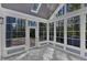 Bright sun room with beautiful windows and a view of nature, lovely flooring, and lots of natural light at 858 Lake Artesia Ln, Fuquay Varina, NC 27526