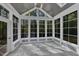 A sunroom offers an inviting space with walls of windows, offering a bright and airy atmosphere at 858 Lake Artesia Ln, Fuquay Varina, NC 27526