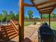 The backyard offers a stone paver patio, a partially covered pool, a well-maintained lawn, and tall privacy fence at 90 Pump Station Rd, Erwin, NC 28339