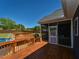 The backyard boasts a pool, screen porch, stone patio, and stairs leading from a wood deck at 90 Pump Station Rd, Erwin, NC 28339