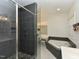 Modern bathroom featuring a tiled shower, soaking tub, and vanity with good lighting at 90 Pump Station Rd, Erwin, NC 28339