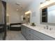 Bright bathroom featuring double sinks, modern fixtures, a soaking tub, and elegant tile at 90 Pump Station Rd, Erwin, NC 28339