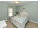 Cozy bedroom with a queen-sized bed, window, and light blue walls at 90 Pump Station Rd, Erwin, NC 28339