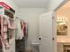 Walk-in closet with shelving, drawers, and clothing racks, adjacent to a bathroom vanity at 90 Pump Station Rd, Erwin, NC 28339