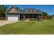 Charming two-story home with well-maintained lawn, attached garage, and inviting front porch at 90 Pump Station Rd, Erwin, NC 28339