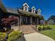 Inviting front porch with brick steps, decorative plants, and rocking chairs for relaxing at 90 Pump Station Rd, Erwin, NC 28339