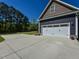 Attached two-car garage with ample driveway parking and traditional white door at 90 Pump Station Rd, Erwin, NC 28339