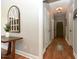 Entryway featuring a wooden table, mirror, and a hallway with hardwood floors at 90 Pump Station Rd, Erwin, NC 28339