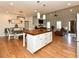 Open concept kitchen and dining area featuring a central island with modern lighting fixtures and hardwood floors at 90 Pump Station Rd, Erwin, NC 28339