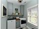 Functional laundry room with washer, dryer, storage cabinets, and a window at 90 Pump Station Rd, Erwin, NC 28339