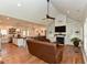 Spacious living room with fireplace, built-in shelving, and view of the modern kitchen at 90 Pump Station Rd, Erwin, NC 28339