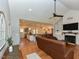 Open-concept living room with hardwood floors, fireplace, and seamless flow into the kitchen at 90 Pump Station Rd, Erwin, NC 28339