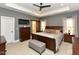 Well lit bedroom with a dark wood bed frame, tray ceilings, and carpeted floors at 90 Pump Station Rd, Erwin, NC 28339