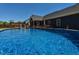 Enjoy swimming in this outdoor pool surrounded by lush greenery, with a screen porch and deck nearby at 90 Pump Station Rd, Erwin, NC 28339