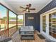 Relax on this screened porch, featuring a ceiling fan and a view of the fenced backyard at 90 Pump Station Rd, Erwin, NC 28339