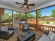 Enjoy outdoor living on this screened porch with seating, a fan, and backyard views at 90 Pump Station Rd, Erwin, NC 28339