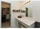 Bathroom vanity with a large mirror, storage drawers, and adjacent walk-in closet at 90 Pump Station Rd, Erwin, NC 28339