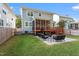 Spacious backyard with a patio, screened-in porch, stairs, and well-maintained lawn at 905 Moye Dr, Raleigh, NC 27606
