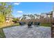Landscaped backyard with stone patio, fire pit, and comfortable outdoor seating at 905 Moye Dr, Raleigh, NC 27606
