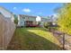 Large, grassy backyard with a view of a screened porch and deck at 905 Moye Dr, Raleigh, NC 27606