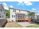 Spacious backyard with a screened in porch, a stone patio, green grass and partial fence for privacy at 905 Moye Dr, Raleigh, NC 27606