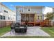 Expansive backyard featuring a stone patio, screened-in porch, and lush green lawn at 905 Moye Dr, Raleigh, NC 27606