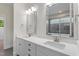 Bright bathroom featuring a double vanity with quartz countertop and modern fixtures at 905 Moye Dr, Raleigh, NC 27606