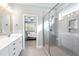 Modern bathroom with glass shower, double vanity and bedroom view at 905 Moye Dr, Raleigh, NC 27606