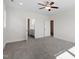 Bedroom featuring a ceiling fan, neutral paint, carpet, and an adjacent bathroom at 905 Moye Dr, Raleigh, NC 27606