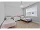 Bedroom with two twin beds, patterned throw pillows, and a dresser at 905 Moye Dr, Raleigh, NC 27606