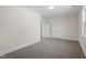Bedroom with gray carpet, neutral walls, and a window overlooking a neighborhood at 905 Moye Dr, Raleigh, NC 27606