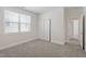 Spacious bedroom with neutral carpet and paint, and a doorway leading to another room at 905 Moye Dr, Raleigh, NC 27606