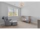 Cozy Bedroom with a glider chair, crib, and window for natural light at 905 Moye Dr, Raleigh, NC 27606