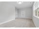 Neutral bedroom featuring carpet floors, a window, and ample closet space at 905 Moye Dr, Raleigh, NC 27606