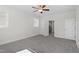 Bright bedroom featuring neutral paint, carpet, ceiling fan, and an adjacent bathroom view at 905 Moye Dr, Raleigh, NC 27606