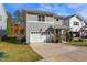 View of home with green grass, lovely landscaping and blue skies on a sunny day at 905 Moye Dr, Raleigh, NC 27606